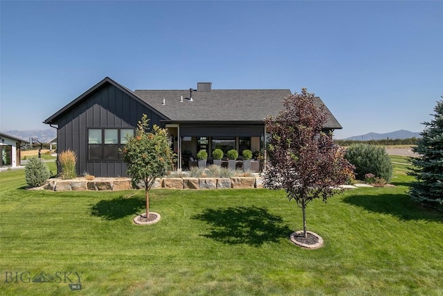 646 Arrow Trl, Bozeman, MT 59718 - back of property featuring board and batten siding, a yard, a shingled roof, and a mountain view