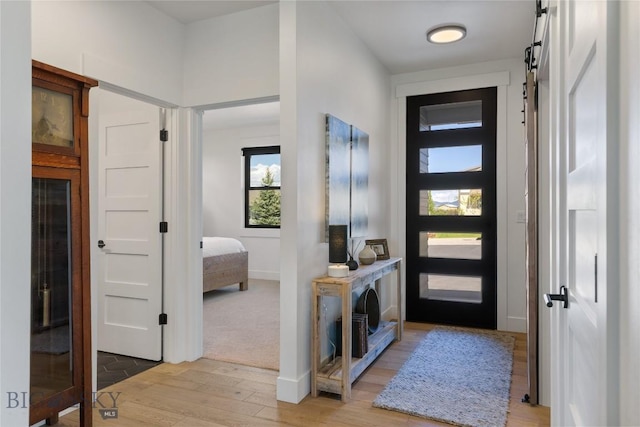 646 Arrow Trl, Bozeman, MT 59718 - entrance foyer featuring light wood-type flooring, baseboards, and a barn door