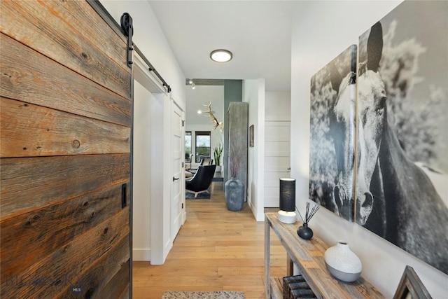 646 Arrow Trl, Bozeman, MT 59718 - hallway with a barn door and light wood finished floors