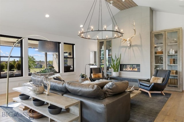 646 Arrow Trl, Bozeman, MT 59718 - living room featuring a chandelier, hardwood / wood-style floors, a high end fireplace, and high vaulted ceiling
