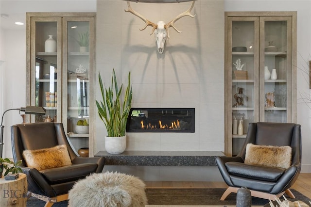 646 Arrow Trl, Bozeman, MT 59718 - sitting room with a tiled fireplace and wood finished floors