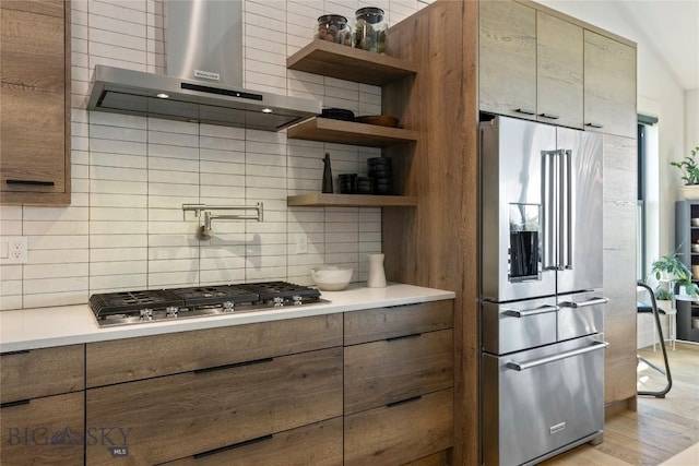 646 Arrow Trl, Bozeman, MT 59718 - kitchen with appliances with stainless steel finishes, wall chimney exhaust hood, tasteful backsplash, open shelves, and light countertops