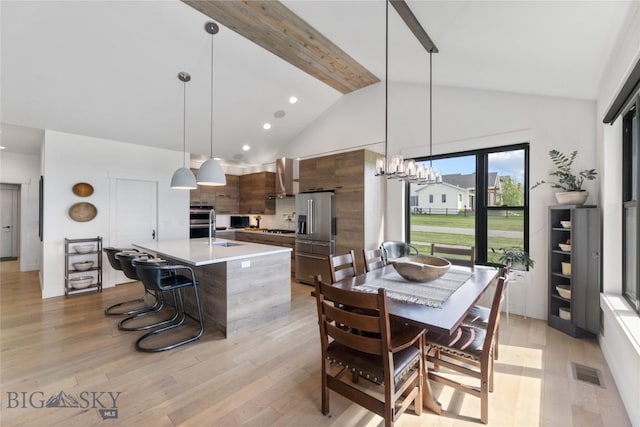 646 Arrow Trl, Bozeman, MT 59718 - dining area featuring light wood-style floors, beam ceiling, a chandelier, high vaulted ceiling, and recessed lighting