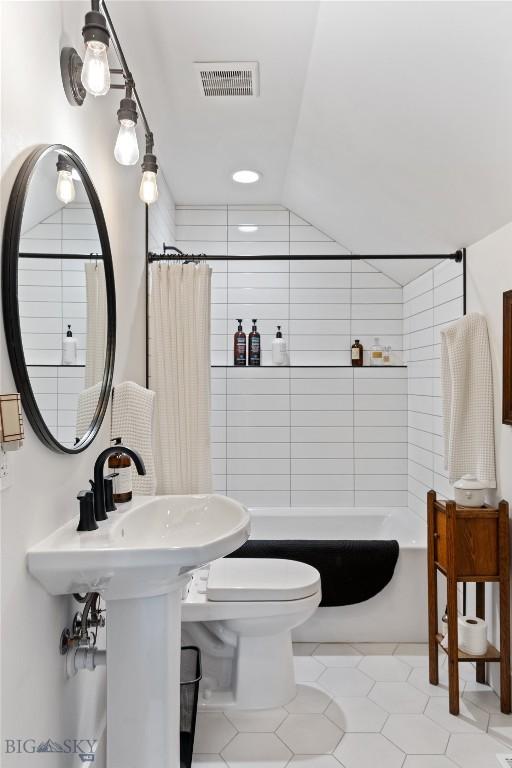 646 Arrow Trl, Bozeman, MT 59718 - full bathroom with toilet, shower / bath combo with shower curtain, tile patterned floors, and tile walls