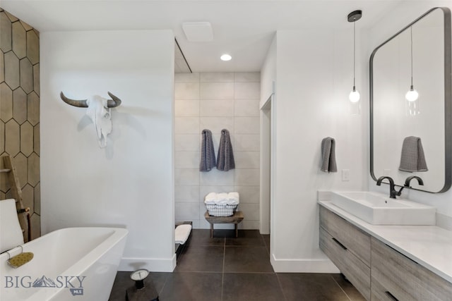 646 Arrow Trl, Bozeman, MT 59718 - bathroom with tile patterned floors, baseboards, a soaking tub, vanity, and recessed lighting