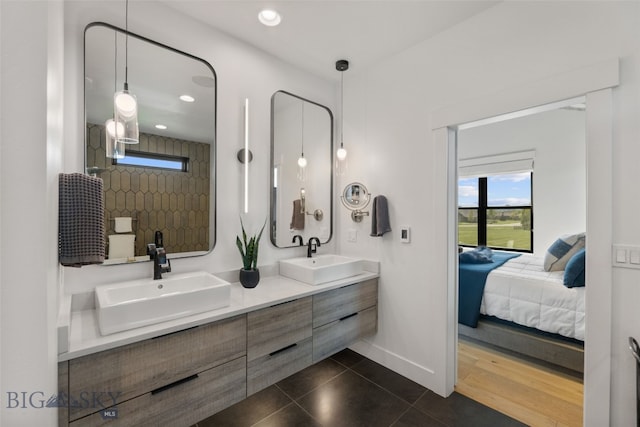 646 Arrow Trl, Bozeman, MT 59718 - full bathroom with connected bathroom, double vanity, recessed lighting, baseboards, and tile patterned floors