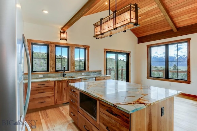 16 Sagittarius Skwy, Emigrant, MT 59027 - kitchen featuring freestanding refrigerator, built in microwave, a sink, healthy amount of natural light, and wooden ceiling