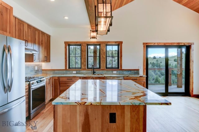 16 Sagittarius Skwy, Emigrant, MT 59027 - kitchen with appliances with stainless steel finishes, brown cabinets, recessed lighting, light wood-style floors, and a center island