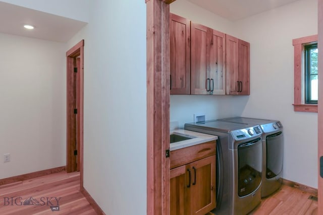 16 Sagittarius Skwy, Emigrant, MT 59027 - laundry room with cabinet space, light wood finished floors, separate washer and dryer, and baseboards