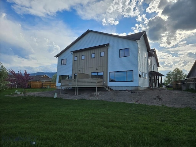 1102 Ridgeview Trl, Livingston, MT 59047 - rear view of house with board and batten siding and a yard