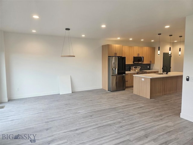 1102 Ridgeview Trl, Livingston, MT 59047 - kitchen with appliances with stainless steel finishes, light wood-style flooring, baseboards, recessed lighting, and open floor plan