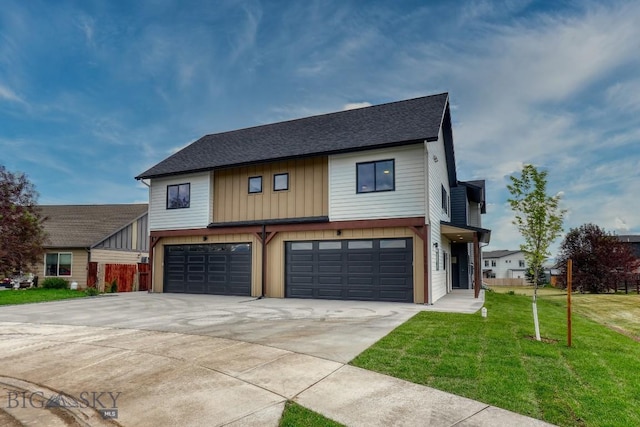 1102 Ridgeview Trl, Livingston, MT 59047 - view of front facade with a garage, a front yard, driveway, a shingled roof, and board and batten siding