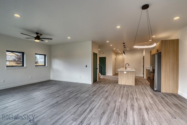 1102 Ridgeview Trl, Livingston, MT 59047 - unfurnished living room with light wood finished floors, recessed lighting, and ceiling fan