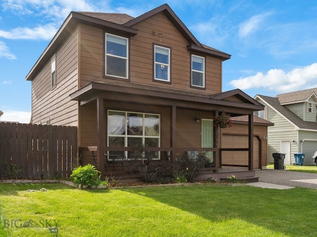 1009 Wyoming St, Belgrade, MT 59714 - view of front of house with covered porch, driveway, and a garage