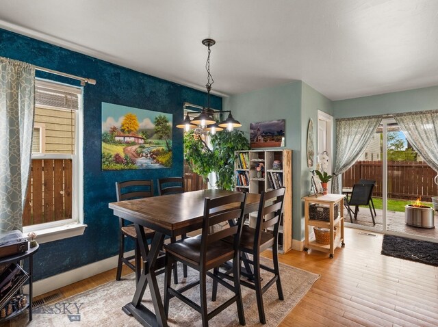 1009 Wyoming St, Belgrade, MT 59714 - dining area featuring a chandelier and hardwood / wood-style floors