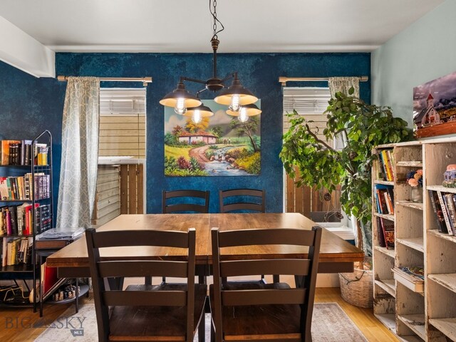 1009 Wyoming St, Belgrade, MT 59714 - dining room with wood finished floors and a chandelier