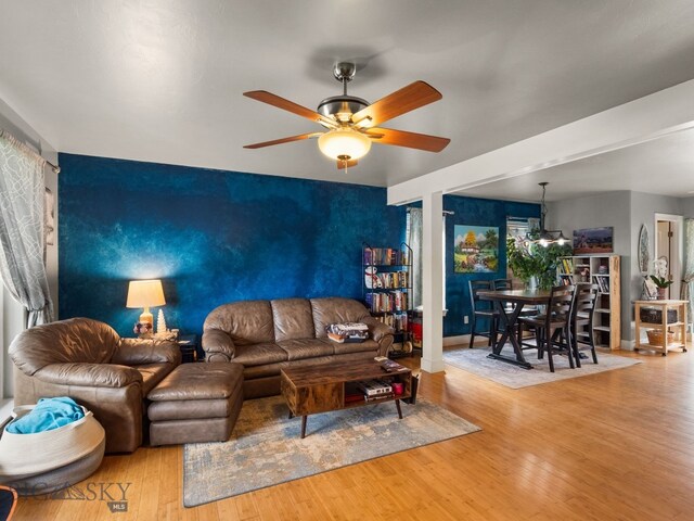 1009 Wyoming St, Belgrade, MT 59714 - living area featuring a ceiling fan, wood finished floors, and an accent wall