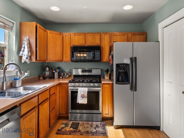 1009 Wyoming St, Belgrade, MT 59714 - kitchen with appliances with stainless steel finishes, brown cabinets, light countertops, light wood-style flooring, and recessed lighting