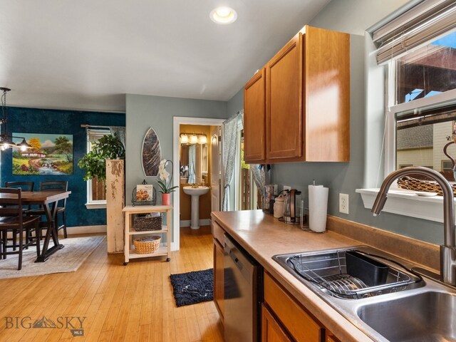 1009 Wyoming St, Belgrade, MT 59714 - kitchen featuring dishwasher, brown cabinetry, light wood-style flooring, recessed lighting, and light countertops