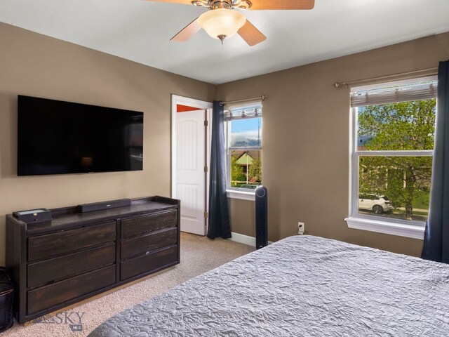 1009 Wyoming St, Belgrade, MT 59714 - bedroom with light carpet, multiple windows, and a ceiling fan