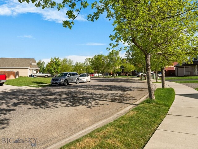 1009 Wyoming St, Belgrade, MT 59714 - view of asphalt road featuring sidewalks and curbs
