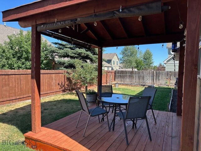 1009 Wyoming St, Belgrade, MT 59714 - deck with outdoor dining space and a fenced backyard