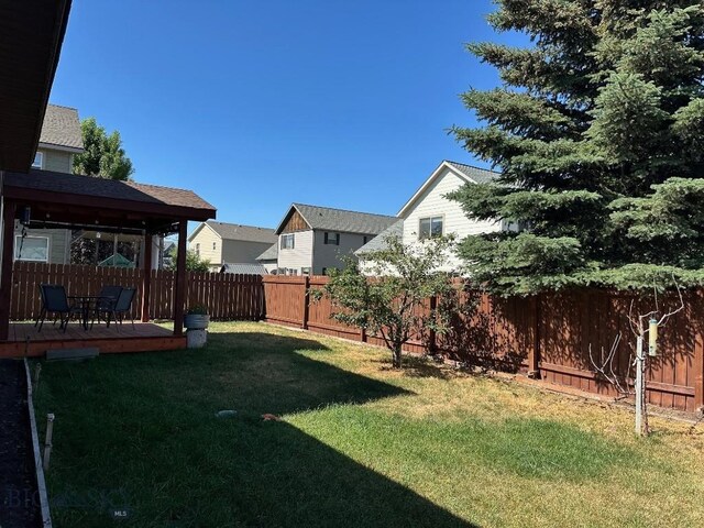1009 Wyoming St, Belgrade, MT 59714 - fenced backyard with a deck