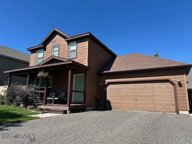 1009 Wyoming St, Belgrade, MT 59714 - view of front of property featuring covered porch, an attached garage, and driveway