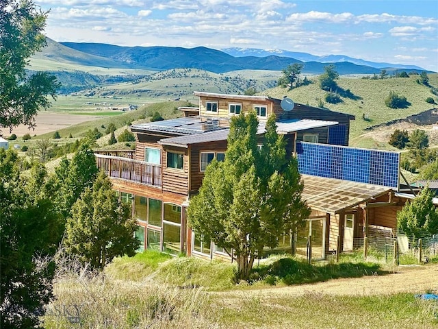400 Broken Creek Rd, Three Forks, MT 59752 - rear view of property featuring solar panels and a deck with mountain view