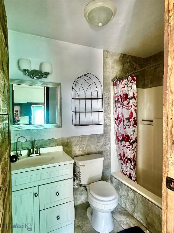 400 Broken Creek Rd, Three Forks, MT 59752 - bathroom with vanity, tile walls, tiled shower / bath, toilet, and tile patterned floors
