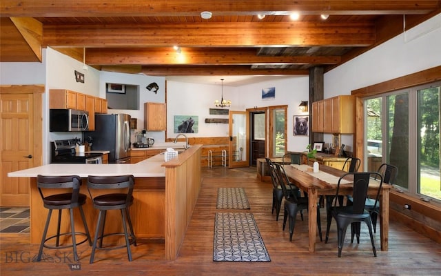 495 Jardine Rd, Gardiner, MT 59030 - kitchen featuring stainless steel appliances, light countertops, wooden ceiling with exposed beams, plenty of natural light, and a sink