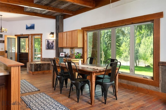 495 Jardine Rd, Gardiner, MT 59030 - dining space featuring beam ceiling, plenty of natural light, hardwood / wood-style floors, and a chandelier