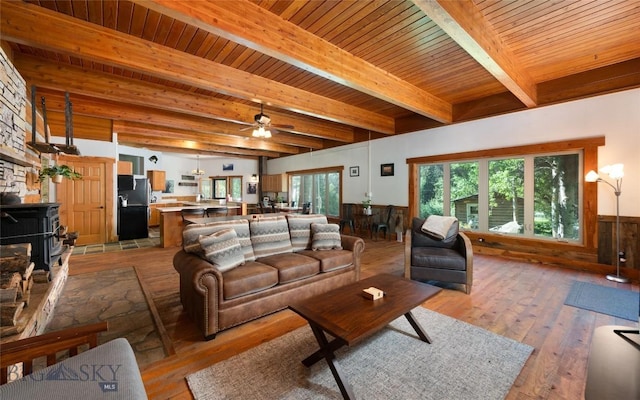 495 Jardine Rd, Gardiner, MT 59030 - living room featuring light wood finished floors, wooden ceiling with exposed beams, wainscoting, and a ceiling fan