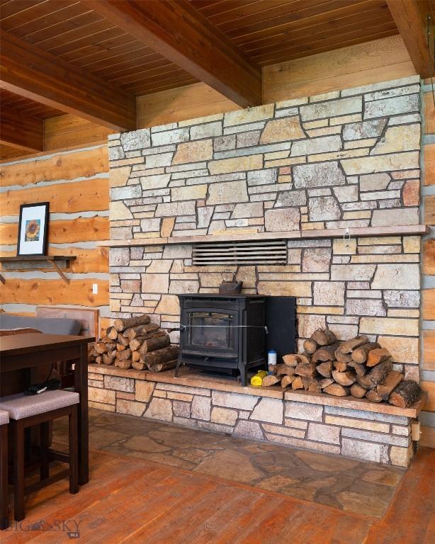 495 Jardine Rd, Gardiner, MT 59030 - detailed view of wooden ceiling with exposed beams, a wood stove, and wood finished floors