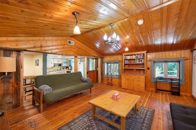495 Jardine Rd, Gardiner, MT 59030 - living area featuring lofted ceiling, wooden ceiling, light wood finished floors, wooden walls, and a chandelier