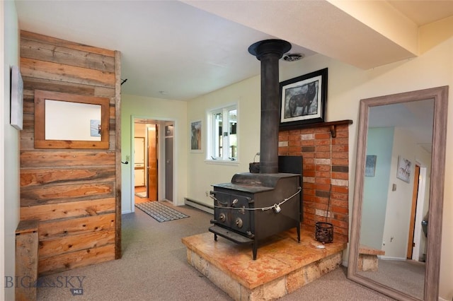 495 Jardine Rd, Gardiner, MT 59030 - living room featuring a wood stove, carpet, and baseboard heating