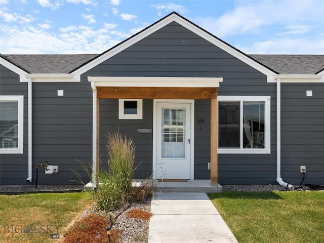 407 Brookline St Unit B, Livingston, MT 59047 - doorway to property featuring a lawn and a shingled roof