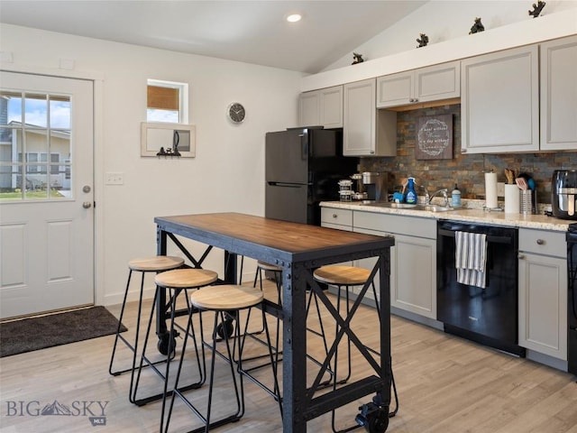 407 Brookline St Unit A, Livingston, MT 59047 - kitchen featuring black appliances, gray cabinets, backsplash, vaulted ceiling, and a sink