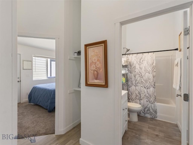 407 Brookline St Unit A, Livingston, MT 59047 - full bath featuring wood finished floors, shower / tub combo with curtain, vanity, toilet, and connected bathroom