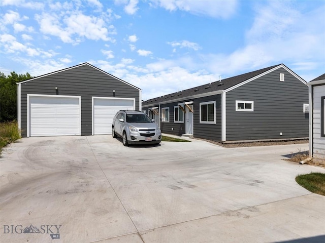 407 Brookline St Unit A, Livingston, MT 59047 - view of front facade featuring concrete driveway, an outdoor structure, and a detached garage