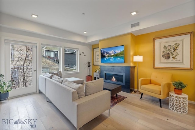 519 E Mendenhall St, Bozeman, MT 59715 - living room with a glass covered fireplace, light wood-style flooring, baseboards, and recessed lighting