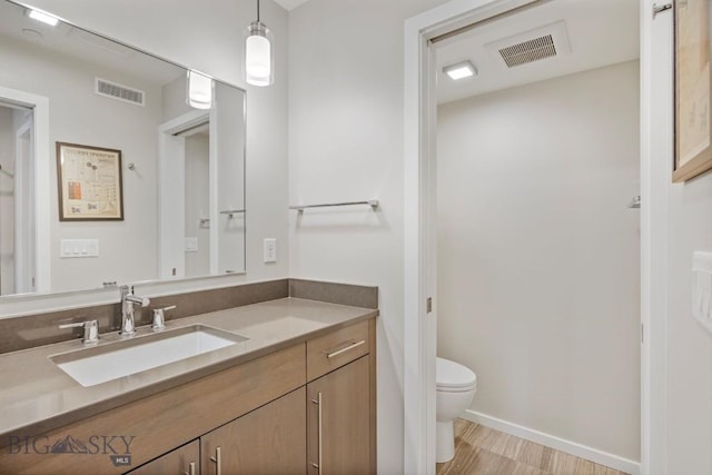 519 E Mendenhall St, Bozeman, MT 59715 - bathroom featuring toilet, vanity, and baseboards