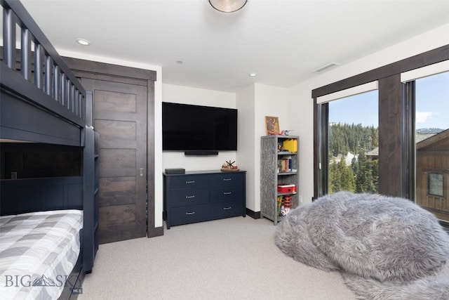 bedroom with light colored carpet, recessed lighting, and baseboards