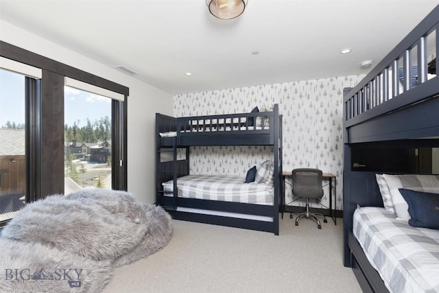 carpeted bedroom with wallpapered walls and recessed lighting