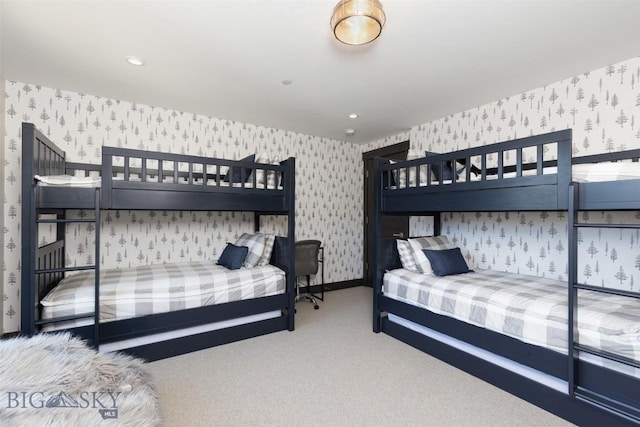 bedroom with wallpapered walls and carpet floors