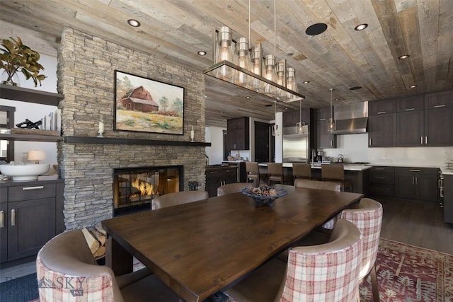 dining area featuring wood ceiling, wood finished floors, a fireplace, and recessed lighting