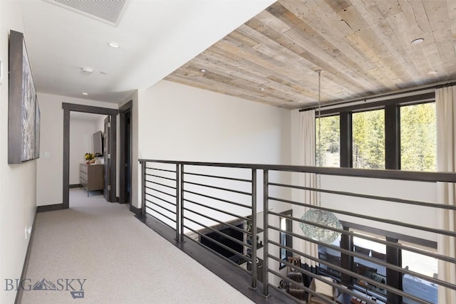 corridor with wood ceiling, carpet floors, baseboards, and recessed lighting