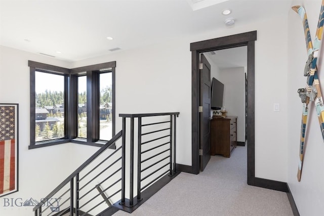 hall with an upstairs landing, baseboards, carpet flooring, and recessed lighting