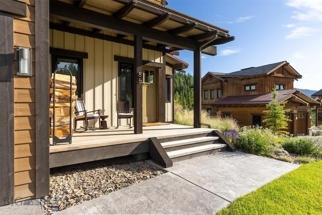 entrance to property featuring covered porch and board and batten siding