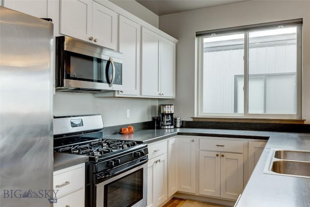 33 Intrepid Dr, Bozeman, MT 59718 - kitchen featuring stainless steel appliances, white cabinetry, and a sink